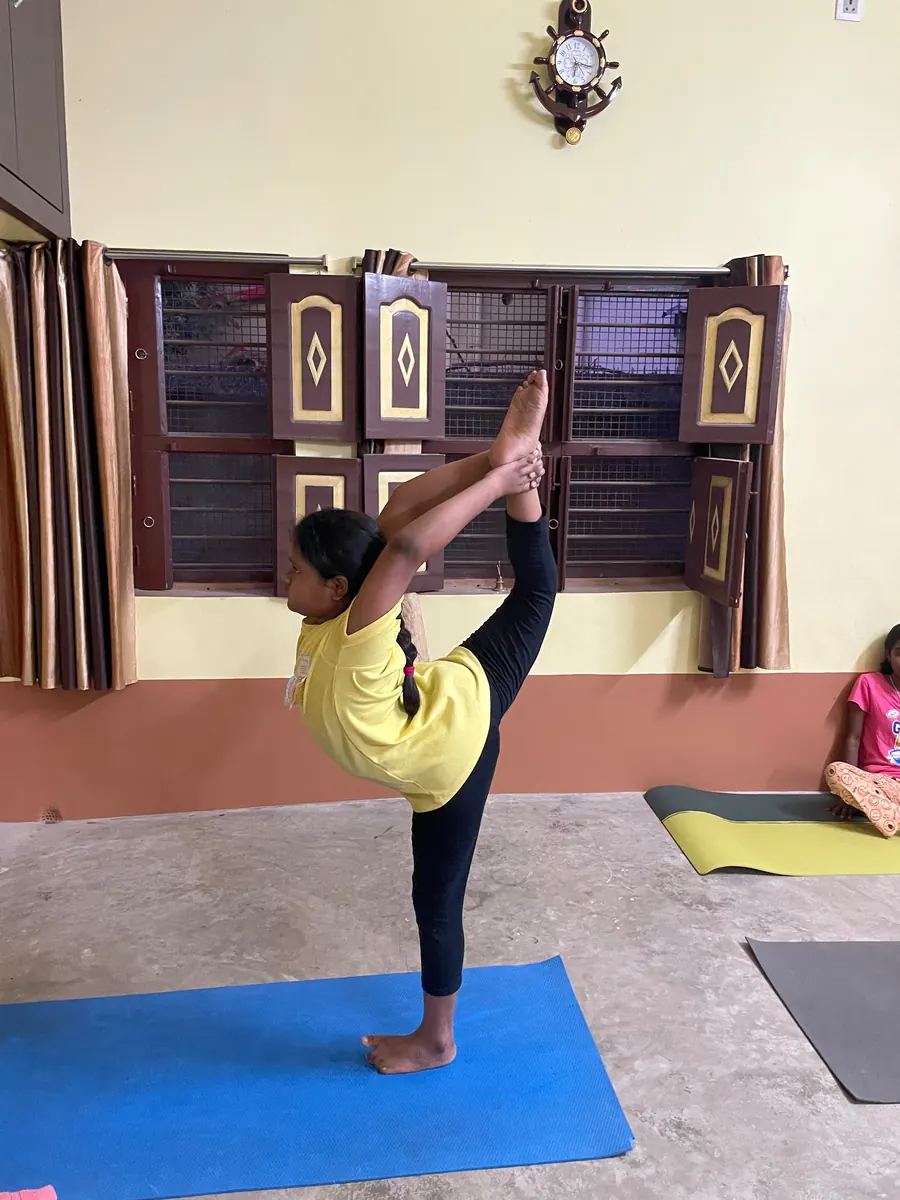 Young student balancing on one leg in dancer pose at the centre